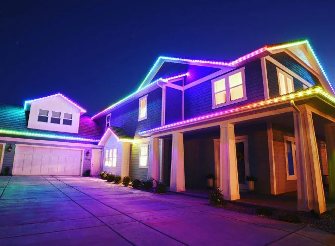 Manufacturer example of permanent EverLights roofline lighting illuminating a home at night