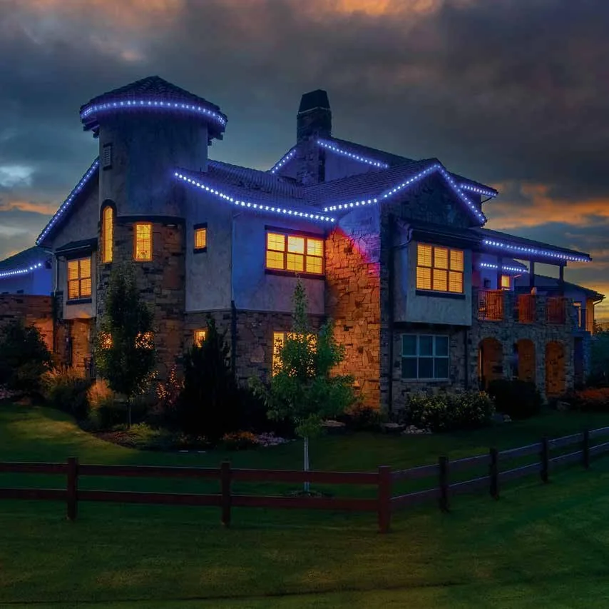 Real Oelo permanent color-changing roofline lighting on a home at dusk