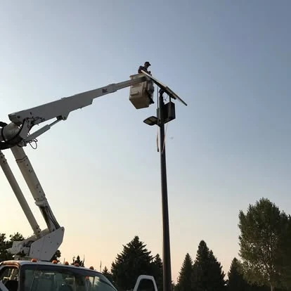 Chesbro Electric bucket truck working on a light pole